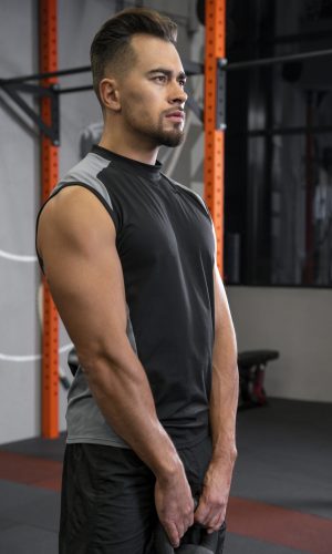 attractive-fit-man-working-out-indoors-with-dumbbells